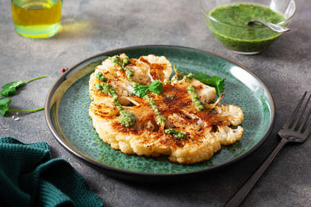 cauliflower steaks with herb sauce and spice. plant based meat substituteの写真素材