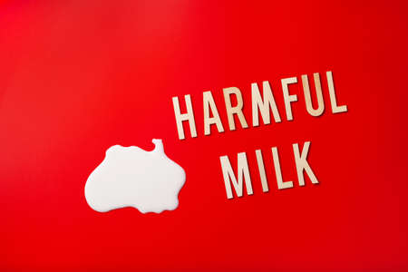 harmful milk word text letters lactose intolerance allergy. milk splatter. avoid dangerous dairyの写真素材