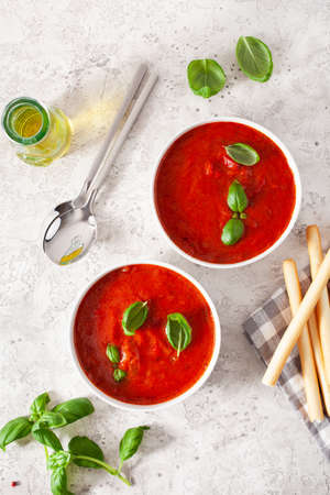 tomato and bell pepper vegetarian soup on green backgroundの写真素材
