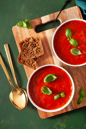tomato and bell pepper vegetarian soup on green backgroundの写真素材