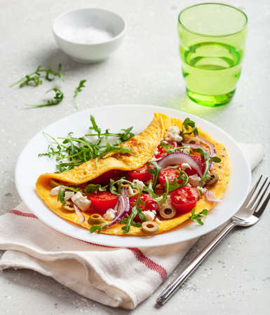 omelette with tomato, feta cheese onion and arugula. healthy keto diet low carb breakfastの写真素材