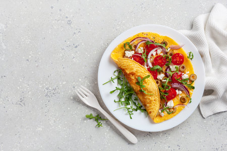 omelette with tomato, feta cheese onion and arugula. healthy keto diet low carb breakfast