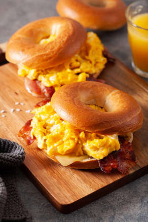 breakfast egg and bacon sandwich on bagel with cheeseの写真素材
