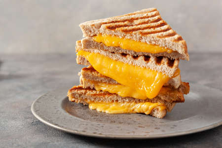 grilled cheese sandwich on gray concrete backgroundの写真素材
