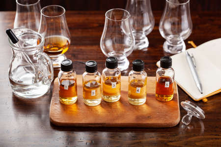 tasting bottles and glasses of whisky spirit brandy cognac. tasting at homeの写真素材