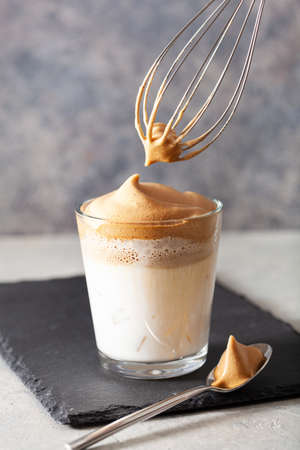 dalgona coffee in glass. trendy Instant coffee whipped with sugar and hot waterの写真素材