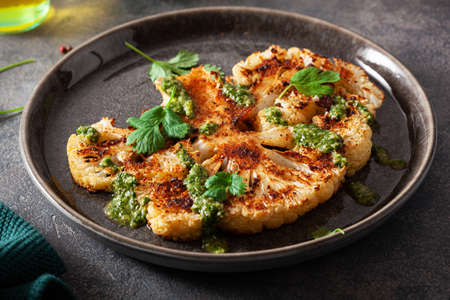cauliflower steaks with herb sauce and spice. plant based meat substituteの写真素材