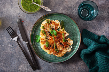 cauliflower steaks with herb sauce and spice. plant based meat substituteの写真素材