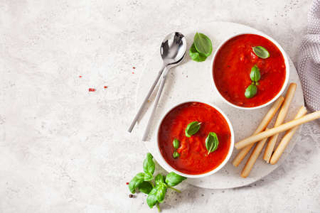 tomato and bell pepper vegetarian soup on green backgroundの写真素材