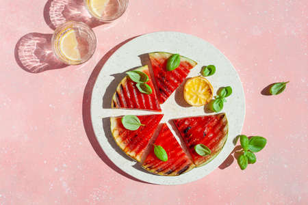 grilled watermelon slices with lemon and basil. summer dessertの写真素材