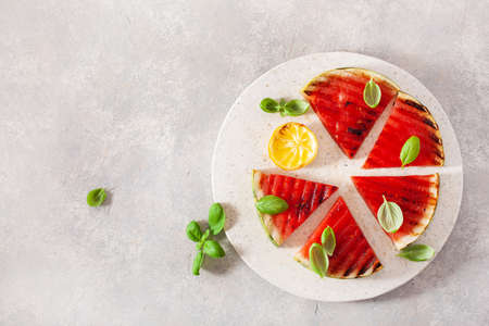 grilled watermelon slices with lemon and basil. summer dessertの写真素材