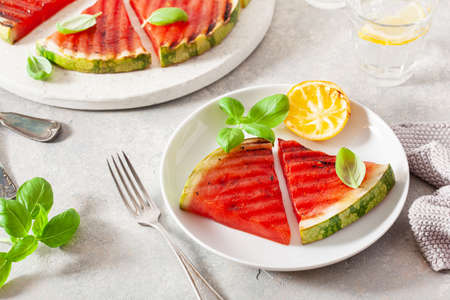 grilled watermelon slices with lemon and basil. summer dessertの写真素材