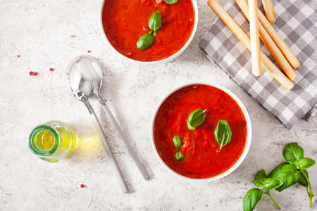 tomato and bell pepper vegetarian soup on green backgroundの写真素材