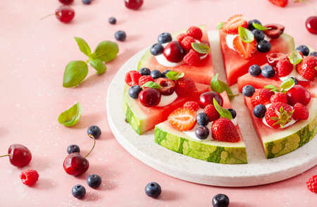 watermelon pizza slices with yogurt and berries, summer dessertの写真素材