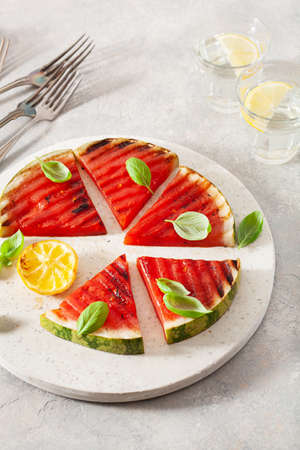 grilled watermelon slices with lemon and basil. summer dessertの写真素材