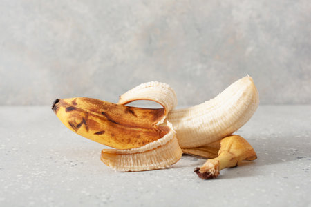 ripe overripe organic bananas on concrete background. ugly food zero waste conceptの写真素材
