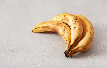 ripe overripe organic bananas on concrete background. ugly food zero waste conceptの写真素材