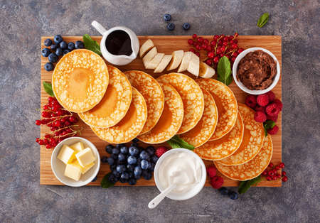 american pancake board with berries maple syrup butterの写真素材