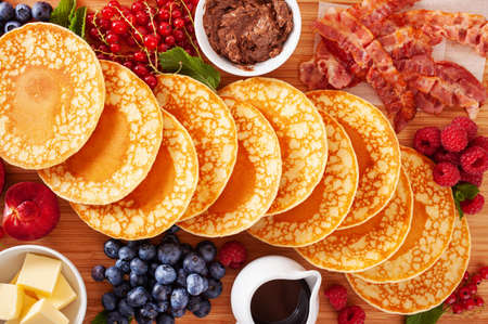 american pancake board with bacon berries maple syrup butterの写真素材