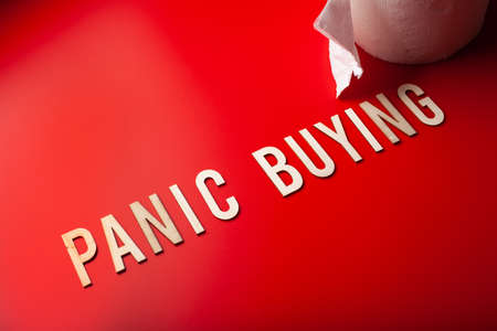 panic buying word toilet paper text wooden letter on red background