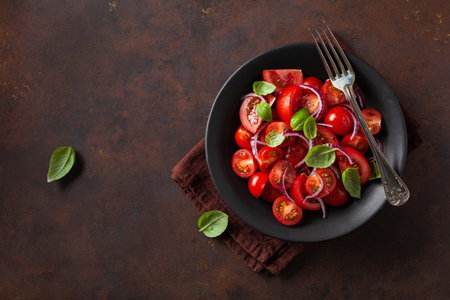 healthy tomato salad with onion basil olive oil and balsamic vinegarの写真素材