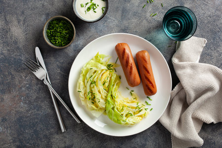 grilled sausages and stewed steamed cabbage with butter, healthy keto mealの写真素材