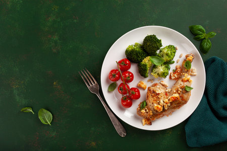 chicken legs backed with feta cheese tomatoes and broccoli, healthy keto mealの写真素材