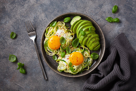 keto low carb breakfast baked spiralized zucchini with eggs and avocadoの写真素材