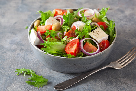 tomato salad with brie cheese olives onion lettuceの写真素材