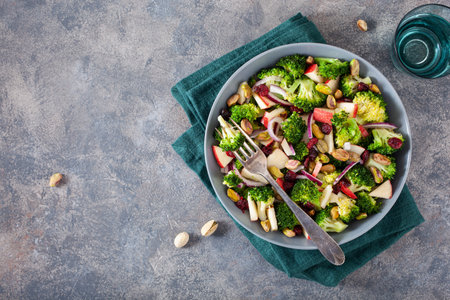 healthy broccoli salad with apple onion dried cranberries pistachio. vegan low carb dietの写真素材