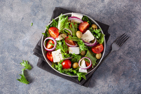 tomato salad with brie cheese olives onion lettuceの写真素材