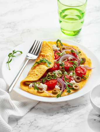 omelette with tomato, feta cheese onion and arugula. healthy keto diet low carb breakfastの写真素材