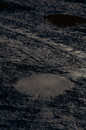dark muddy road background with tire traces, dirty groundの写真素材