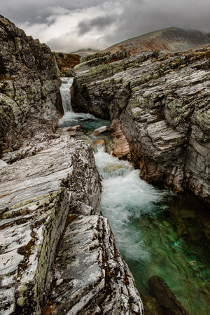 autumn mountain landscape of Rondane National Park in Norway, waterfall and near Peer Gynt hyttaの写真素材
