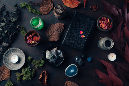Witchcraft still life concept with potion, spell book, herbs ingredients candles and magical equipmentの写真素材