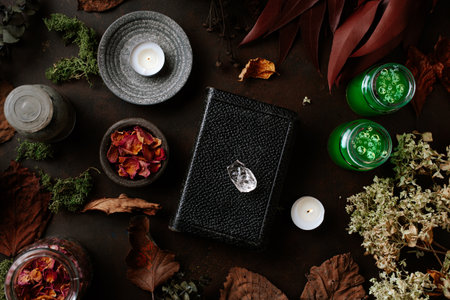 Witchcraft still life concept with potion, spell book, herbs ingredients candles and magical equipmentの写真素材