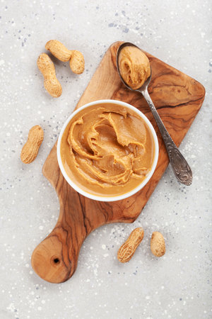 smooth peanut butter in bowl on gray backgroundの写真素材