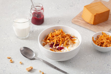 rice pudding with Norwegian brunost traditional brown cheese and raspberry jam