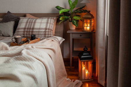 cozy scandinavian bedroom interior in natural tones, blanket lantern houseplantsの写真素材