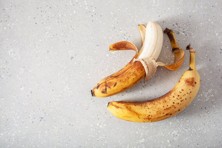 ripe overripe organic bananas on concrete background. ugly food zero waste conceptの写真素材