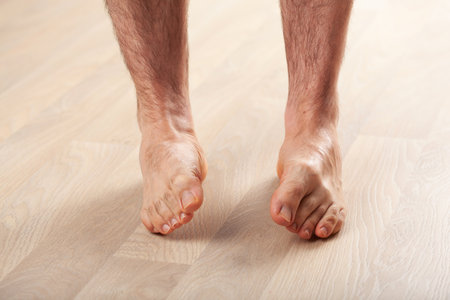 man doing flatfoot correction gymnastic exercise at homeの写真素材