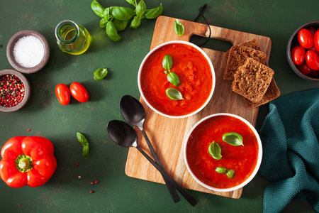 tomato and bell pepper vegetarian soup on green backgroundの写真素材