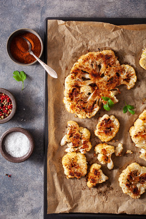 cauliflower steaks with herb and spice on baking tray. plant based meat substituteの写真素材