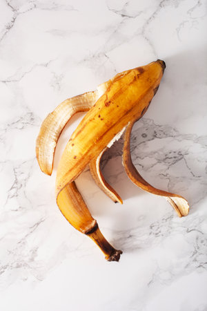 ripe overripe organic banana peel on marble background. ugly food zero waste conceptの写真素材