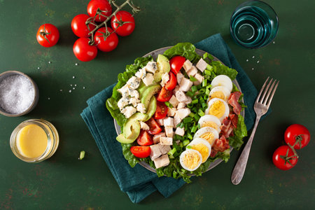 healthy American Cobb salad with egg bacon avocado chicken tomato. hearty keto low carb dietの写真素材