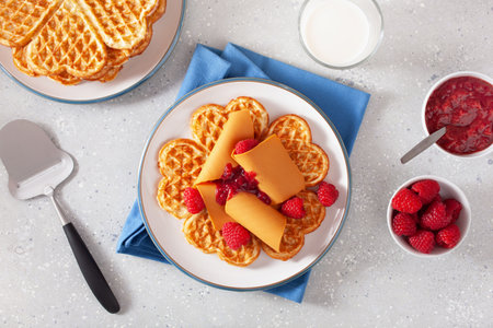 waffles with Norwegian brunost traditional brown cheese and raspberry jamの写真素材