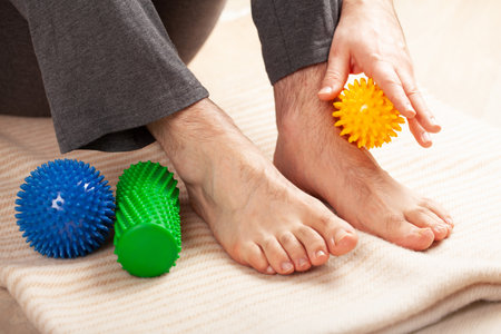 man doing flatfoot correction self massage at homeの写真素材