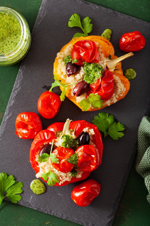 stuffed bell peppers with quinoa tomatoes olives and herb sauce chimichurriの写真素材