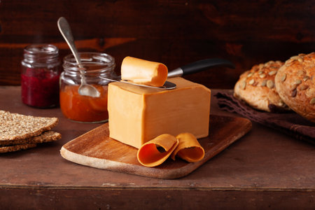 Norwegian brunost traditional brown cheese on rustic backgroundの写真素材