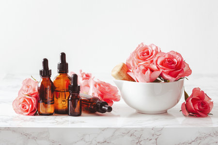 essential oils in bottles rose flowers. alternative medicine spa aromatherapyの写真素材